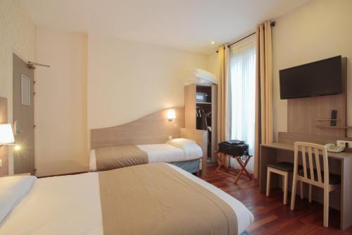 Postel nebo postele na pokoji v ubytování Grand Hotel du Loiret