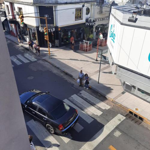 a black car is parked at a street intersection at Departamento San Martín in Paraná