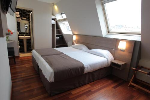 Postel nebo postele na pokoji v ubytování Grand Hotel du Loiret