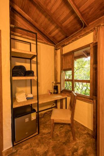 a room with a desk and a chair and a window at Ecohotel Piedemonte in Salento