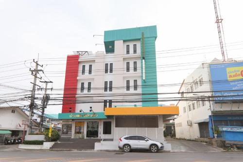 a car parked in front of a building at G House Hotel in Hua Hin