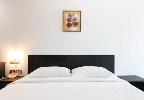 Postel nebo postele na pokoji v ubytování G House Hotel