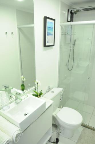 a bathroom with a toilet and a sink and a shower at BIEN ÊTRE in Brasília