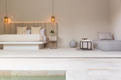 a bedroom with a bed and a chair at Cielo Boutique Hotel & Spa Samui in Bophut 