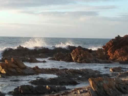 a view of the ocean with waves crashing on rocks at Belle Vista in Wirrina Cove