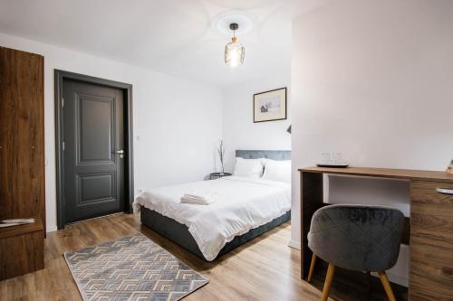 a bedroom with a bed and a desk with a chair at Roua Bucovinei in Sadova
