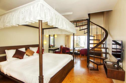 a bedroom with a large bed and a spiral staircase at Blue Country Resort in Panchgani