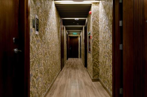 a corridor of a hallway with wooden floors and walls at Goldberry Suites and Hotel Cebu in Cebu City