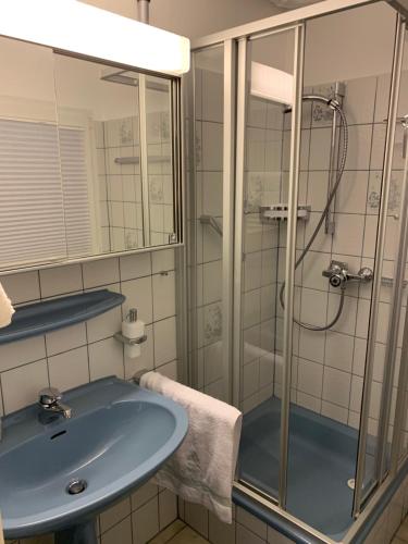 a bathroom with a sink and a shower at Ferienwohnung Nicole in Bad Harzburg