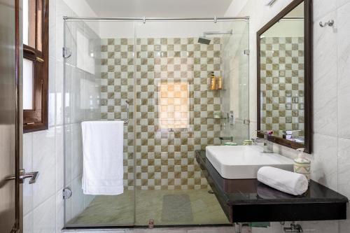 a bathroom with a sink and a shower at StayVista at The Haven in Kasauli