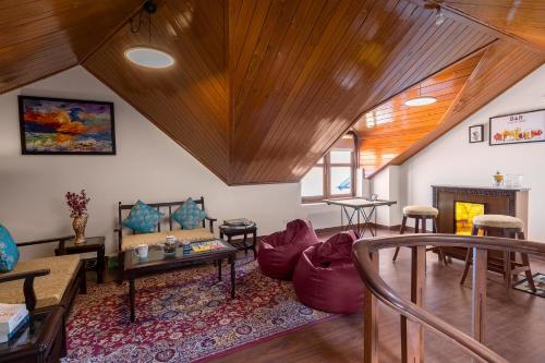 a living room with a couch and a table at StayVista at The Haven in Kasauli