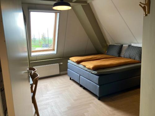 a small bedroom with a bed and a window at Hotel Workum in Workum