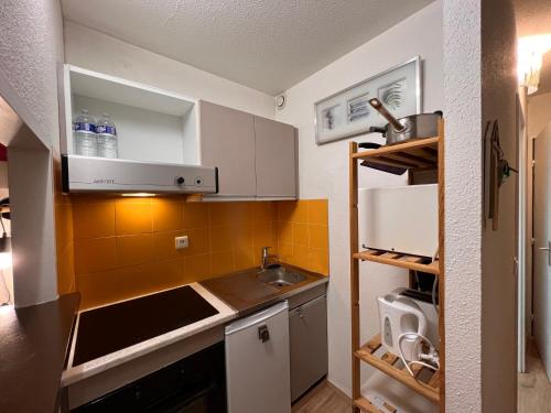 a small kitchen with a sink and a counter at Plaza Valberg centre studio cabine in Valberg