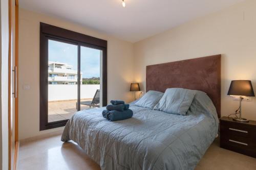 a bedroom with a bed with a teddy bear on it at Penthouse La Cala De Mijas in La Cala de Mijas