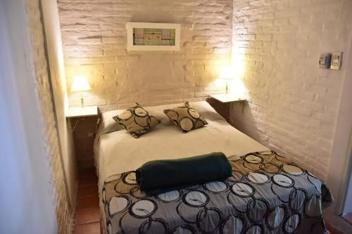 a bedroom with a bed with two pillows on it at Puerto Sosiego in Gualeguaychú