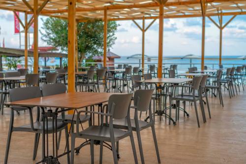 a row of tables and chairs in a restaurant at Armas Green Fugla Beach in Avsallar