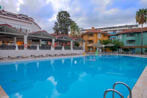 a large swimming pool in front of a building at Armas Green Fugla Beach in Avsallar