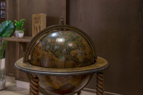 a globe sitting on a chair in a room at Hôtel Les Voyageurs in Bastia