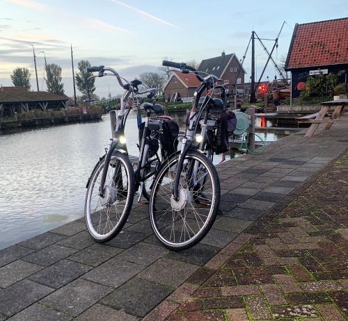 two bikes are parked next to a river at Hotel Workum in Workum