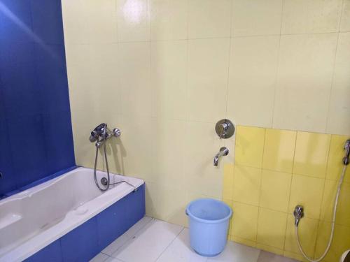 a bathroom with a tub and a bucket in it at Ivy Cosy House, 2 BHK, Khandala in Khandāla