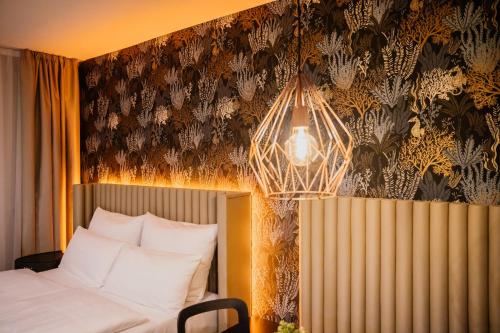 a bedroom with a bed and a chandelier at Rioca Stuttgart Posto 4 in Stuttgart
