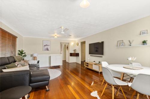 a living room with a couch and a table at KOZYGURU ALBION CHARMING HOUSE WITH 3 BEDROOM PARKING -QAL035 in Brisbane