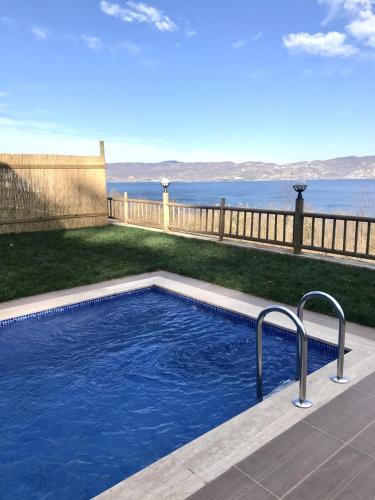 a swimming pool with a view of the water at Woodlodge Country Sapanca in Sapanca
