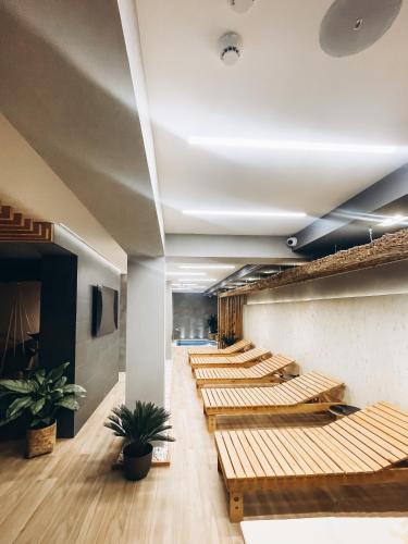 a row of wooden benches in a room at BUKA Apart-Hotel & SPA in Bukovel