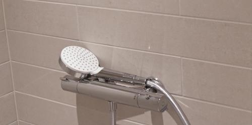 a shower with a blow dryer in a bathroom at Nordsjællands Ferieboliger in Frederiksværk