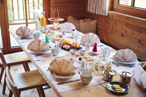a table with plates and bowls of food on it at Omesberg-Hütt'n in Lech am Arlberg