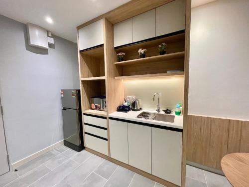 a kitchen with a sink and a refrigerator at LV Modern Suite Langkawi by Zervin in Kuah