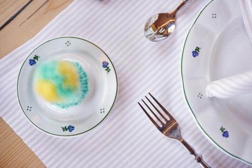 a plate with food on a table with a fork at Omesberg-Hütt'n in Lech am Arlberg