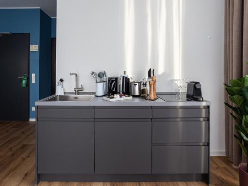 a kitchen with a counter top with a sink at Limehome Mönchengladbach Fliethstraße in Mönchengladbach