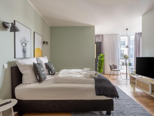a bedroom with a bed and a living room at Limehome Mönchengladbach Fliethstraße in Mönchengladbach