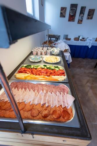 a buffet line with many different types of food at Margaréta Apartman és Üdülőház in Bogács