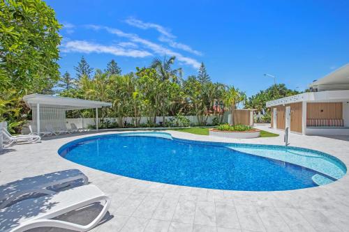 a swimming pool in the backyard of a house at De Ville Apartments in Gold Coast