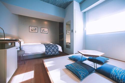 a bedroom with a bed and a table in a room at Asakusa Kaede 浅草楓 in Tokyo