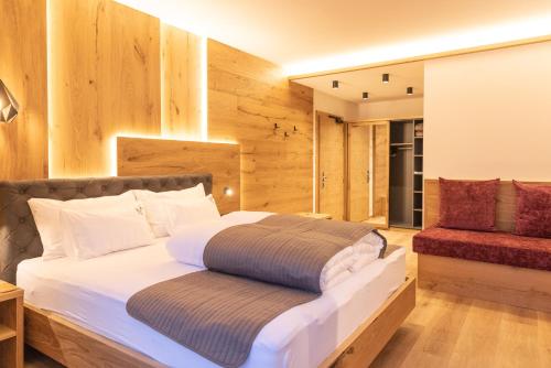 ein Schlafzimmer mit einem Bett mit einer Holzwand in der Unterkunft Der WALZL in Innsbruck