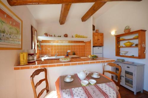 une cuisine avec une table, des chaises et un comptoir dans l'établissement Maison de caractère à Ceyreste - Terrasse et jardin clôturé, à Ceyreste