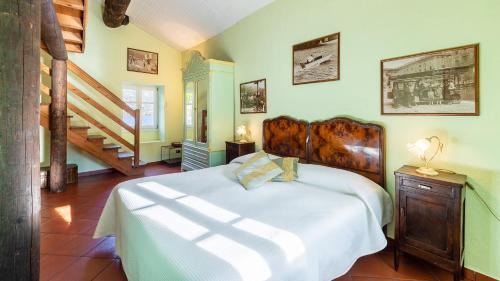 a bedroom with a large bed and a staircase at VILLA RIVETTA 6&2, Emma Villas in Rezzonico