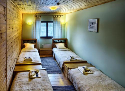 a room with three beds in it with a window at LVM tūrisma un atpūtas centrs "Ezernieki" in Meirāni