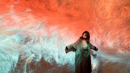 a woman standing in front of a painting of clouds at Yokohama Tokyu REI Hotel in Yokohama