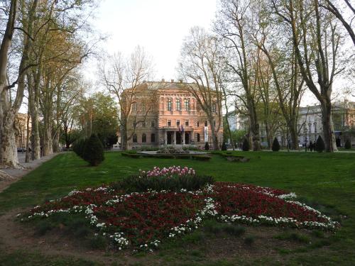 a house with a flower garden in front of it at Zagreb 1911 in Zagreb