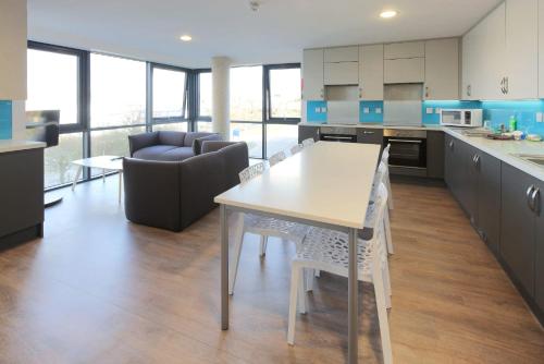 a kitchen with a table and chairs in a room at Student Only Riverside Way in Winchester in Winchester