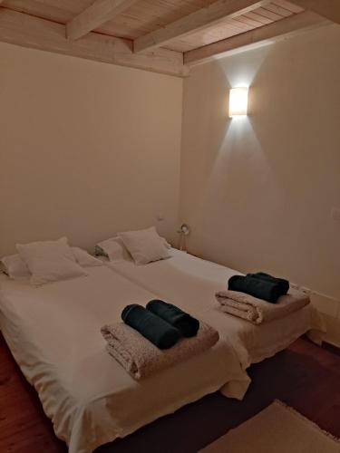 a bedroom with a white bed with two pillows on it at NAMOR-Apartamento Tres Balcones in Ribadeo