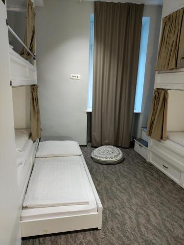 a room with two bunk beds and a window at Downtown Boutique Hostel in Zadar