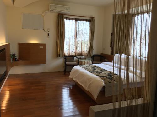 Postel nebo postele na pokoji v ubytování Qiao Kela Ti Homestay
