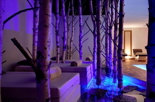 a room with trees with purple lights on the floor at LA CHENEAUDIÈRE - Hôtel Spa - Relais & Châteaux - Restaurant étoilé in Colroy-la-Roche