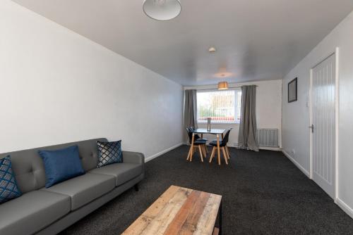 a living room with a couch and a table at Cornsay in Stockton-on-Tees