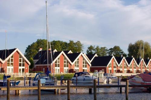 a group of houses with boats in a marina at SATAMA Sauna Resort & SPA in Wendisch Rietz